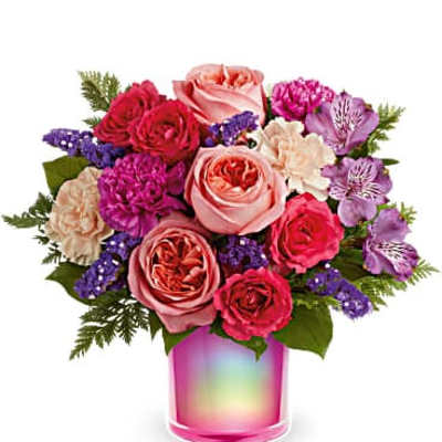 Mixed pink and purple bouquet in a rainbow glass vase