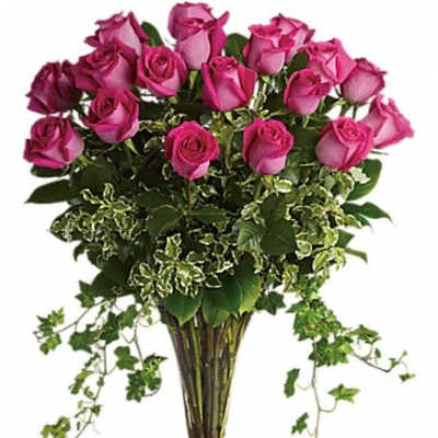 Tall bouquet of pink roses in a clear glass vase
