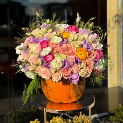 Mixed pastel bouquet in an orange pumpkin container