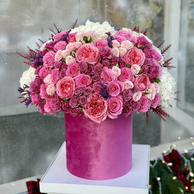 Pink and white rose arrangement in a tall magenta box