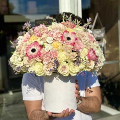 Large pastel bouquet of roses and pink anemones in a white hat box