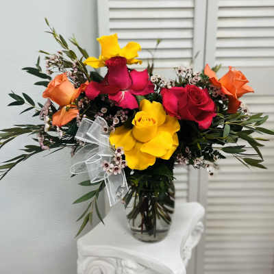 Bouquet of multicolored roses in a clear glass vase