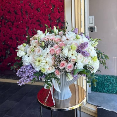 Large bouquet of pink and white roses in a white vase