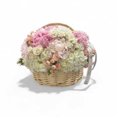 Pink and white flower arrangement in a wicker basket