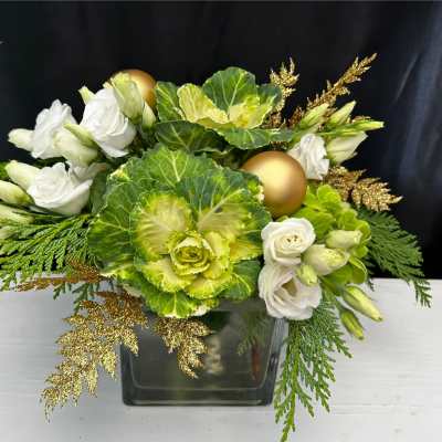 White roses and green ornamental cabbage in a glass vase with gold accents