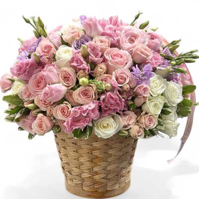 Pink and white rose bouquet in a woven basket