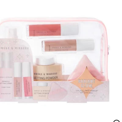 Pink makeup gift set with setting spray, lip gloss, powder, and a pouch