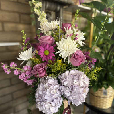 Pink and white mixed bouquet in a magenta vase