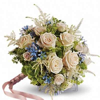 Cream rose bouquet with blue accents and a pink ribbon handle