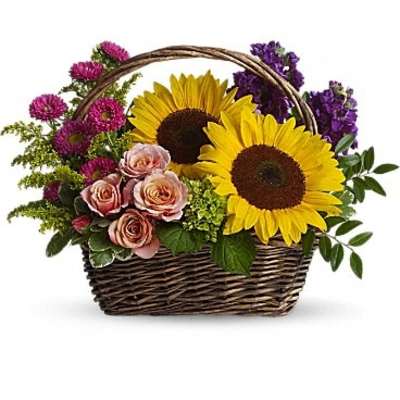 Basket of sunflowers, pink roses, and purple flowers