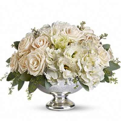 Cream roses and white flowers arranged in a silver pedestal bowl