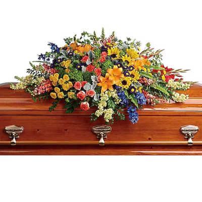 Colorful floral casket spray on a wooden coffin