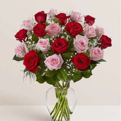 Red and pink roses in a clear glass vase