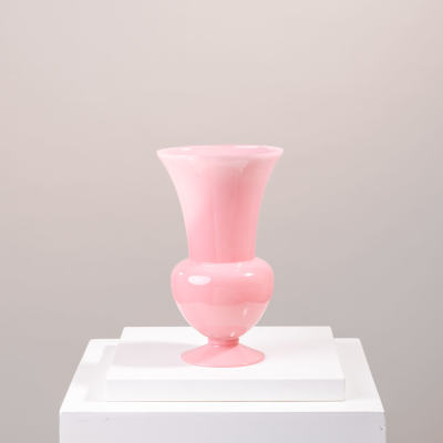 Pink glass vase on a white pedestal