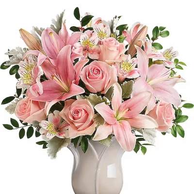 Pink lilies and roses arranged in a ceramic vase
