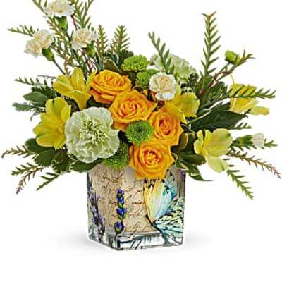Yellow and white floral arrangement in a butterfly-patterned vase