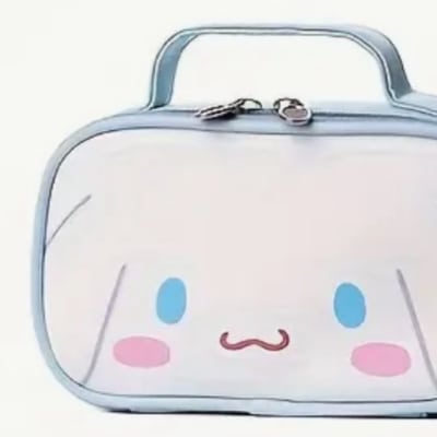 Cute white zippered pouch with a cartoon face and blue handle