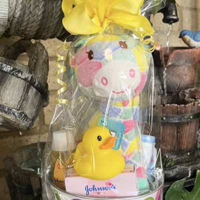 Baby gift basket with a plush toy, rubber duck, and toiletries
