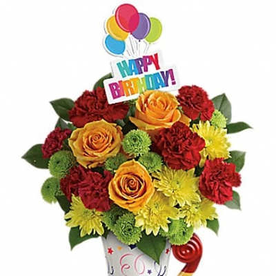 Birthday bouquet with roses, carnations, and balloons in a decorated vase