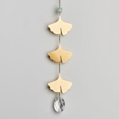 Gold ginkgo leaf hanging ornament with blue bead and clear teardrop crystal on a chain