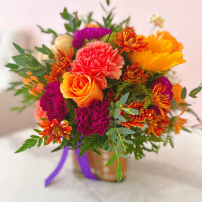 Bright mixed bouquet with roses, carnations, and chrysanthemums in a vase