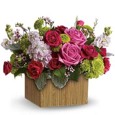 Mixed pink and red flower arrangement in a wooden box