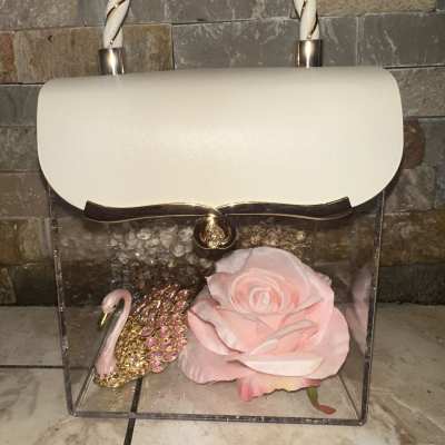 Clear handbag with a pink rose inside and a swan charm