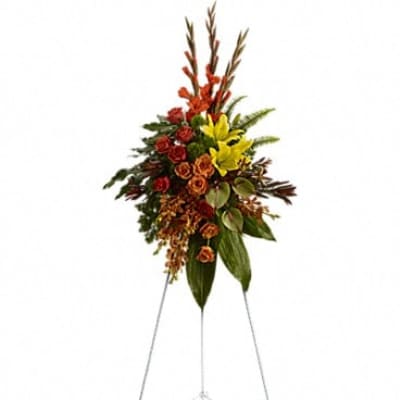 Tall floral spray on a metal easel with red, orange, and yellow flowers