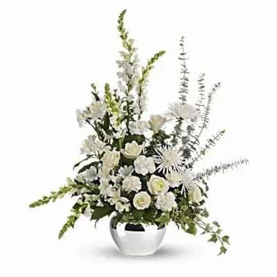 White floral arrangement in a white vase with tall spiky stems