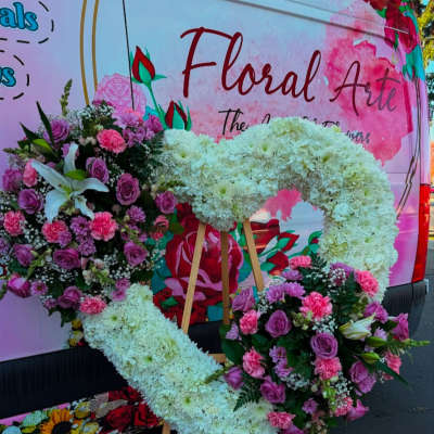 Large floral heart wreath on easel with pink and white flowers