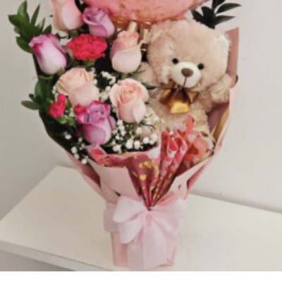 Pink rose bouquet with a teddy bear and ribbon wrap