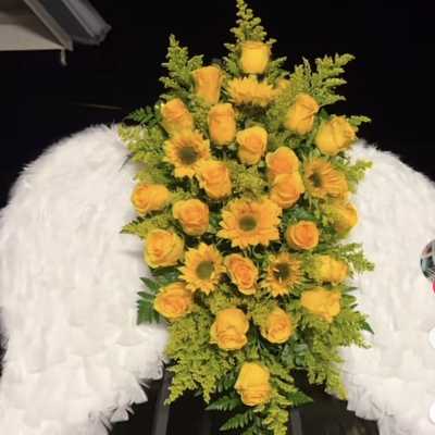 Yellow rose and sunflower standing spray with white angel wings