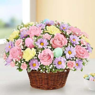 Basket of pink roses, purple daisies, and pastel carnations