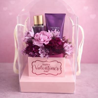 Pink flower gift box with Victoria's Secret items and a Happy Valentine's Day card