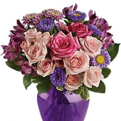 Pink and purple mixed bouquet in a purple vase