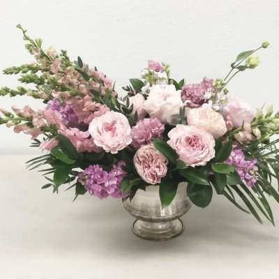 Pink and lavender floral arrangement in a silver vase