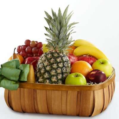 Fruit basket with pineapple, bananas, grapes, apples, and oranges
