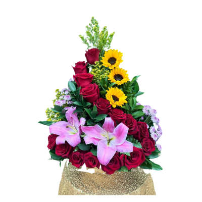 Triangular arrangement of red roses, pink lilies, and yellow sunflowers on a gold-covered base