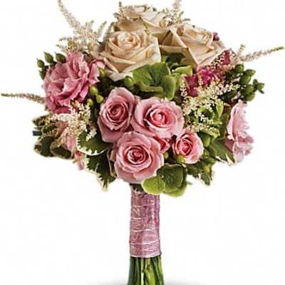 Bouquet of pink and cream roses with green accents
