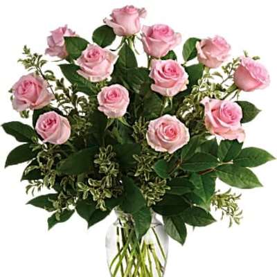 Pink roses arranged in a clear glass vase