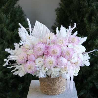 Pink and white bouquet in a woven basket