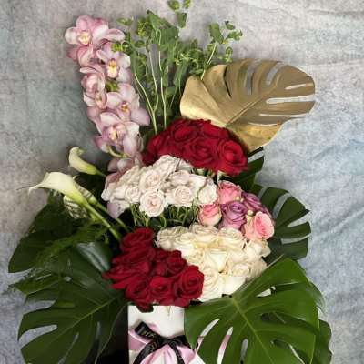Monstera Leaves, Roses, Cymbidium & More Floral Arrangement