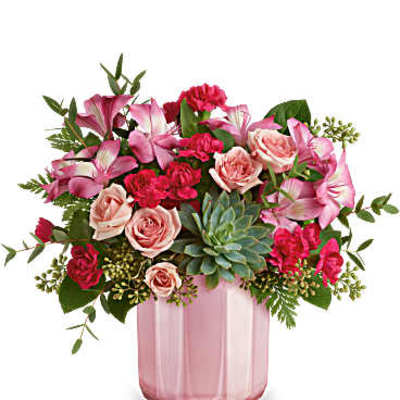 Pink and red mixed bouquet in a pink glass vase
