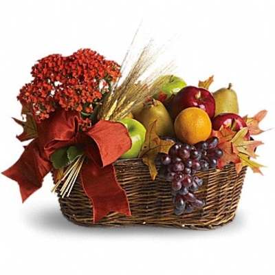 Autumn gift basket with flowers, fruit, and a red bow