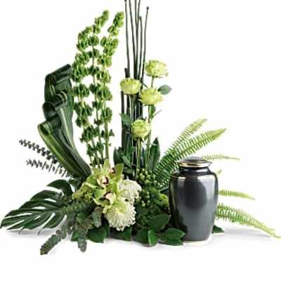 Green floral arrangement with a black urn