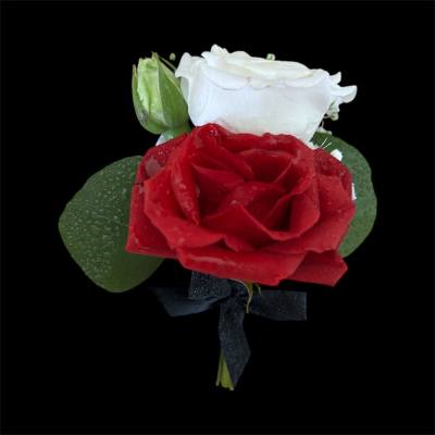 Red and white rose boutonniere with a black ribbon