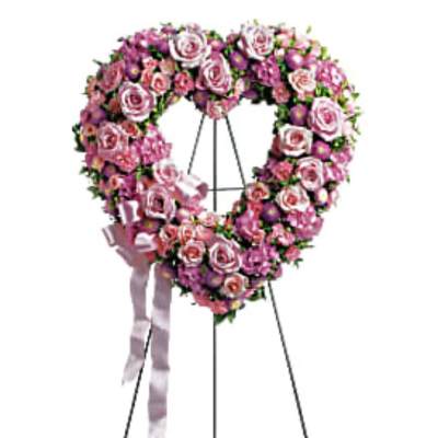Pink and white floral heart wreath on a standing easel with ribbon