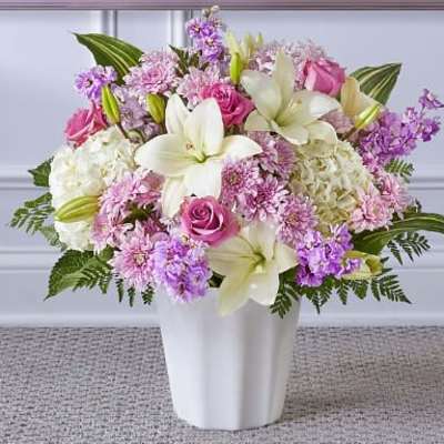Pink and white floral arrangement in a white vase