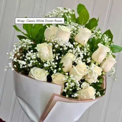 Bouquet of white roses with baby's breath wrapped in white paper