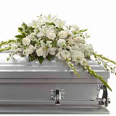 White floral spray on a silver casket